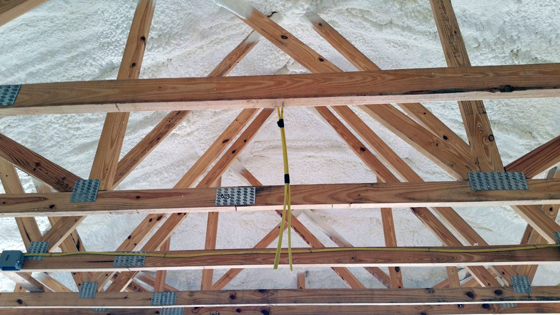 Attic trusses with spray foam insulation on the roof deck