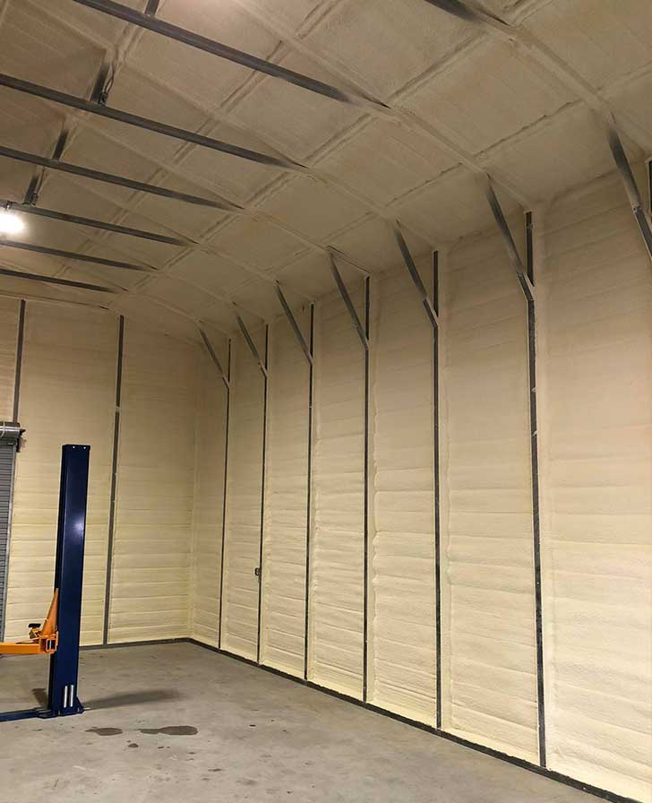 Metal building walls insulated with spray foam