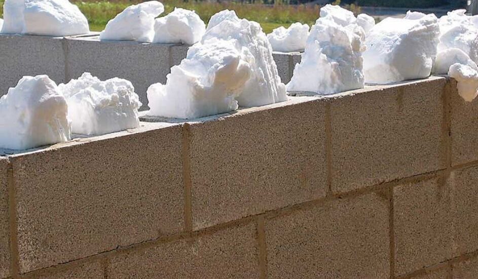 Foam injected into concrete block wall cores